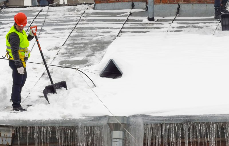 Removing snow off of a commercial building